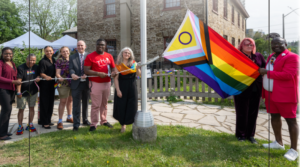 People gathered to raise the Intersex Inclusive Progress Pride flag at Montgomery's Inn.